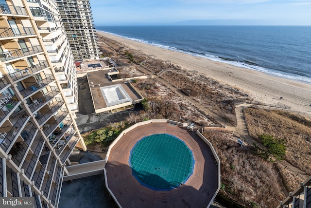 drone / aerial view featuring a view of the beach and a water view