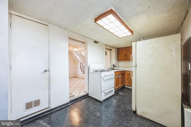 kitchen with sink and white appliances