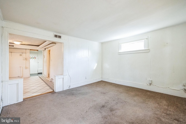 unfurnished room featuring light carpet