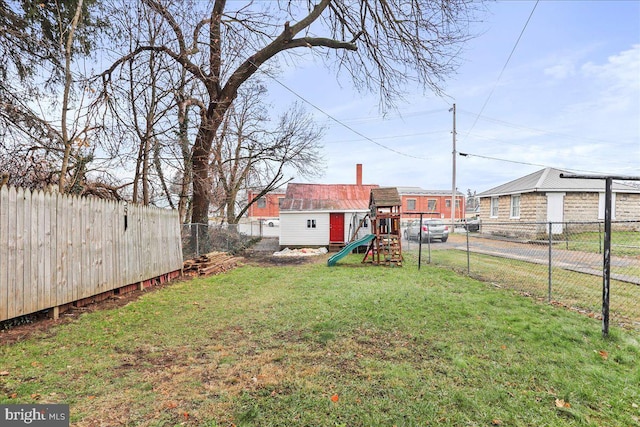 view of yard featuring a playground and an outdoor structure