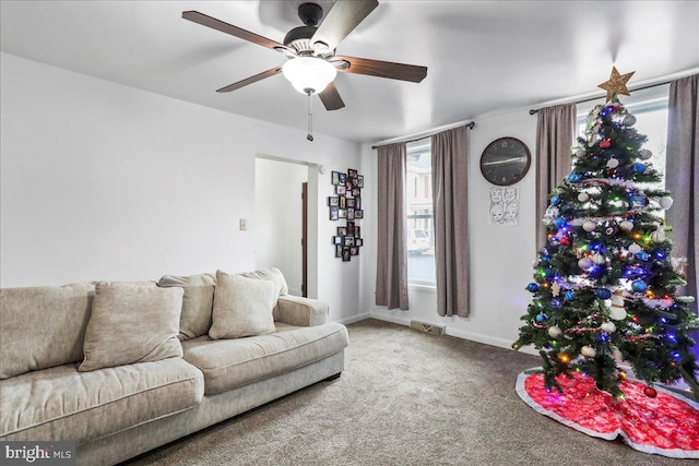 carpeted living room with ceiling fan