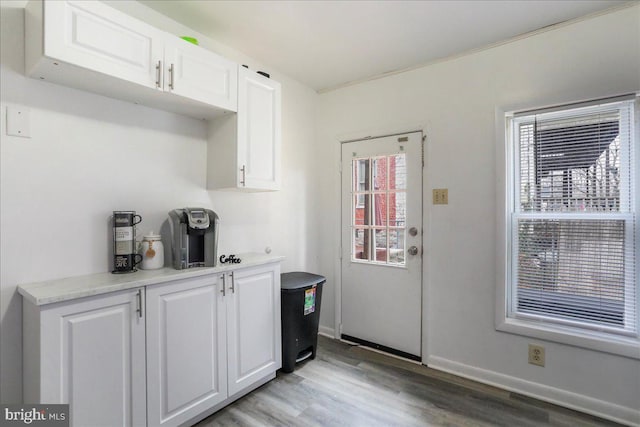 kitchen with white cabinets and light hardwood / wood-style flooring