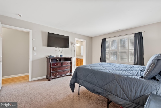 carpeted bedroom with ensuite bathroom