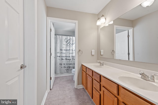 bathroom featuring tile patterned floors, vanity, curtained shower, and toilet