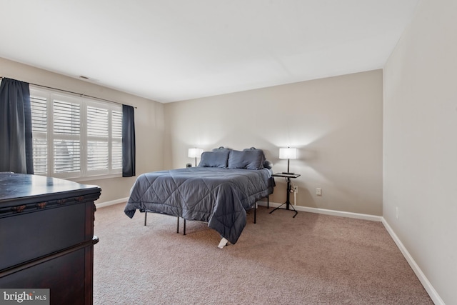 bedroom featuring light carpet