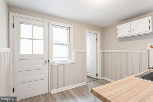 1345 Cooksie St, Baltimore, MD 21230 - doorway to outside with light wood-style flooring and a wainscoted wall