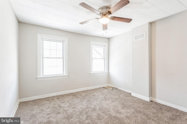 unfurnished room with carpet flooring, ceiling fan, and a healthy amount of sunlight