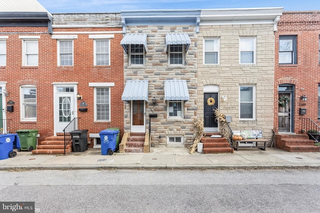 1345 Cooksie St, Baltimore, MD 21230 - townhome / multi-family property featuring entry steps and stone siding