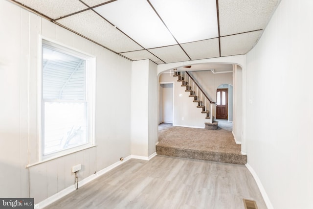 interior space featuring hardwood / wood-style flooring and a paneled ceiling