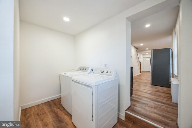 laundry area featuring dark wood-type flooring and independent washer and dryer