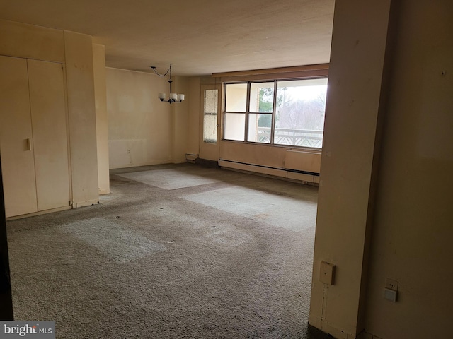 unfurnished room featuring light carpet, a baseboard heating unit, and a chandelier