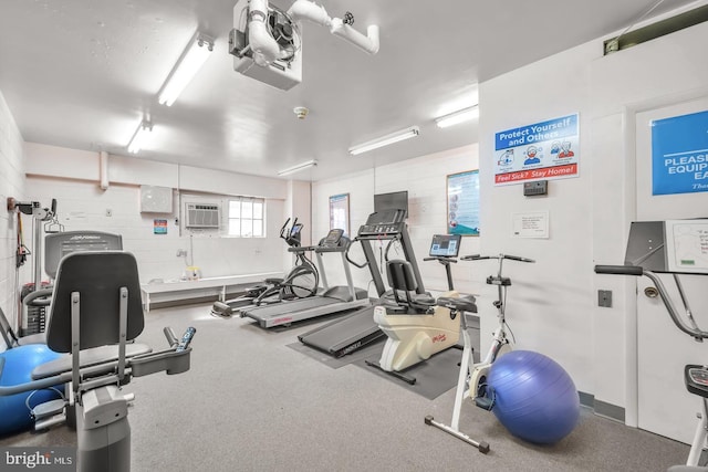 exercise room featuring a wall unit AC