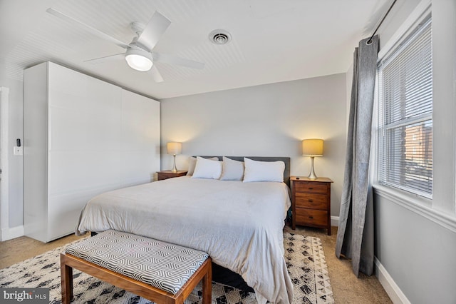 bedroom featuring light carpet and ceiling fan