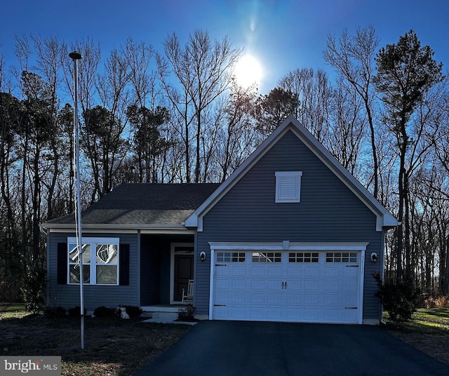 view of front facade with aphalt driveway and an attached garage