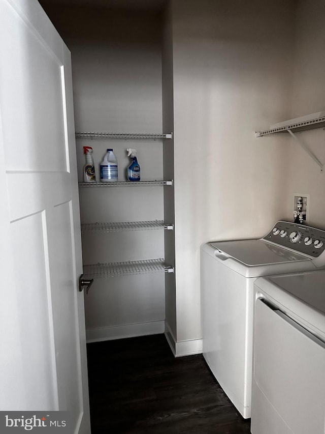 laundry room with dark wood-type flooring and washer and clothes dryer