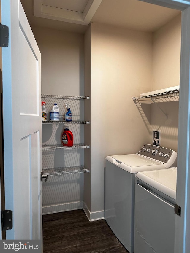 clothes washing area with separate washer and dryer and dark hardwood / wood-style floors