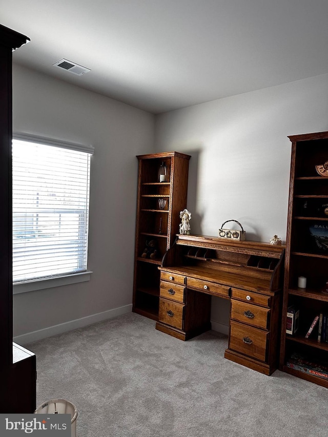 office area featuring light carpet