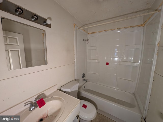 full bathroom featuring vanity, shower / washtub combination, toilet, tile walls, and tasteful backsplash