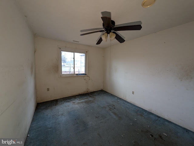 empty room with ceiling fan and carpet floors