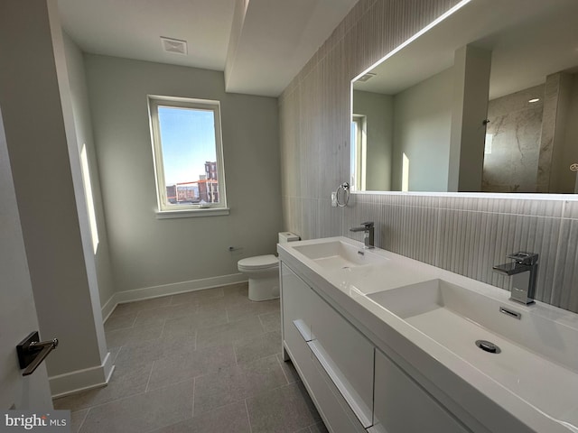 bathroom featuring tile patterned flooring, vanity, and toilet