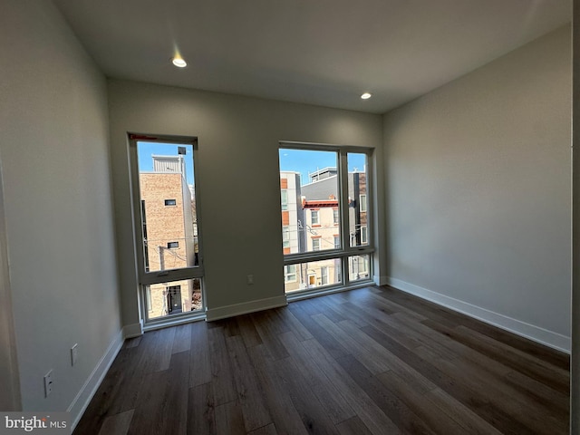 empty room featuring dark hardwood / wood-style floors and a wealth of natural light