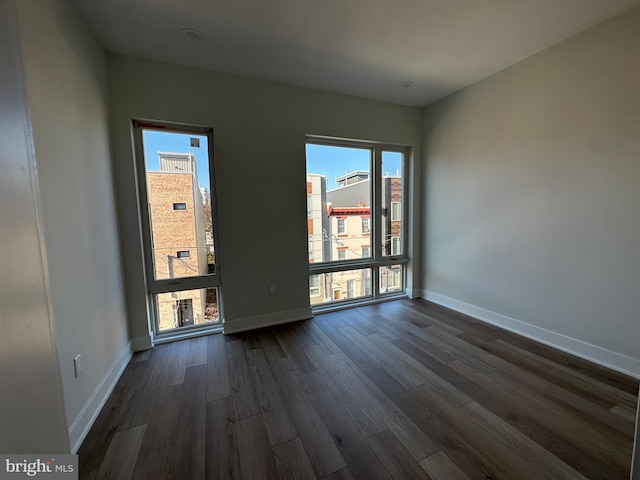 spare room featuring dark hardwood / wood-style flooring