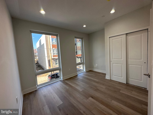 unfurnished bedroom featuring hardwood / wood-style flooring and a closet