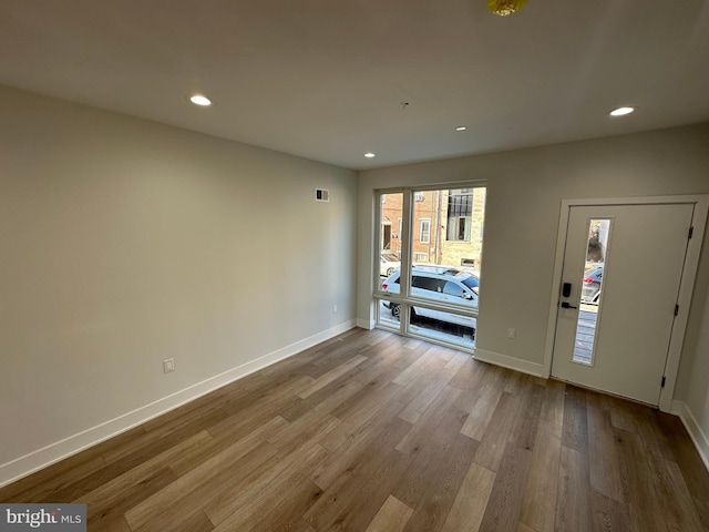 empty room with light hardwood / wood-style flooring