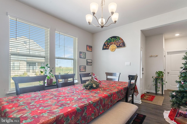 dining area featuring dark hardwood / wood-style flooring and a chandelier