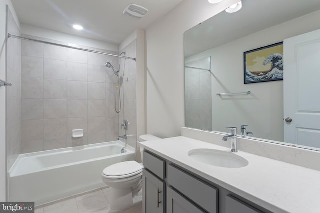 full bathroom with toilet, vanity, tile patterned floors, and tiled shower / bath