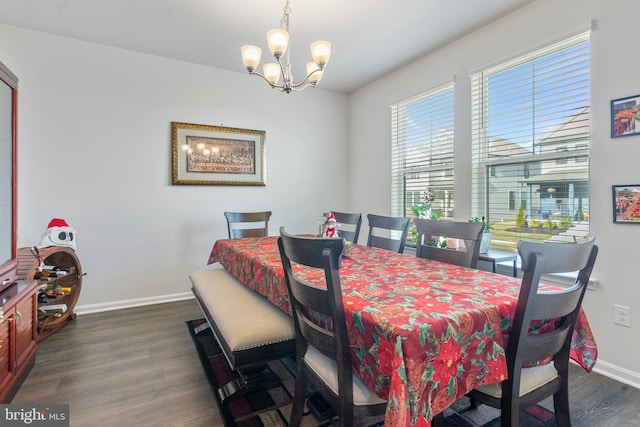 dining area with dark hardwood / wood-style flooring and a notable chandelier