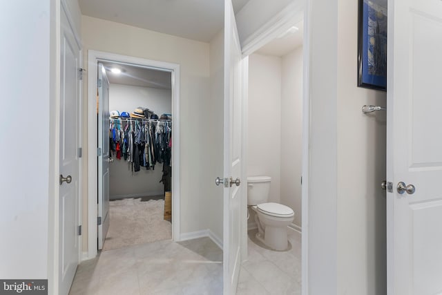 bathroom featuring tile patterned flooring and toilet