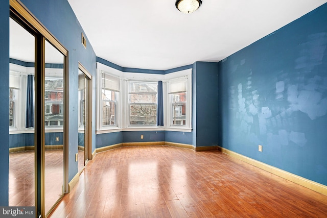 spare room featuring hardwood / wood-style floors