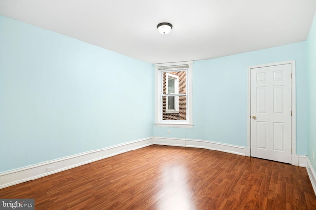 empty room with dark hardwood / wood-style floors