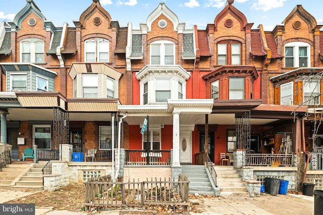 townhome / multi-family property featuring covered porch