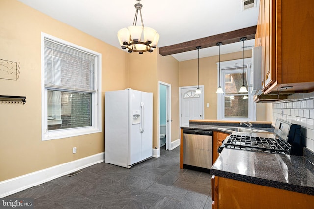 kitchen with appliances with stainless steel finishes, backsplash, decorative light fixtures, beamed ceiling, and a chandelier