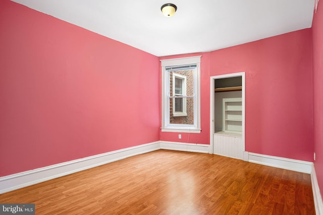 spare room with wood-type flooring