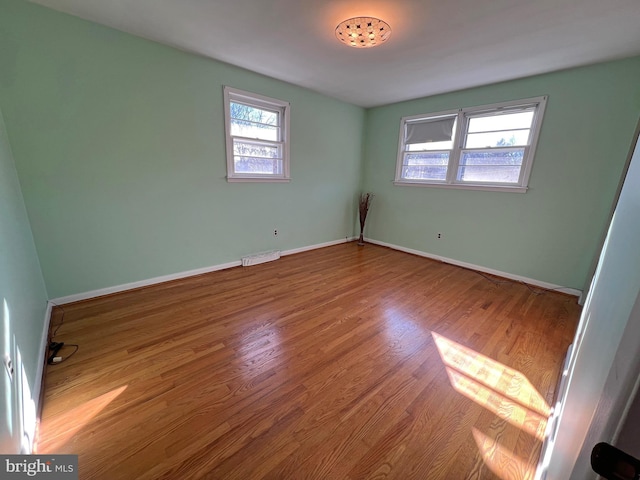 spare room featuring hardwood / wood-style floors