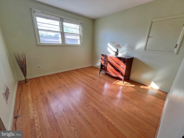 spare room with light hardwood / wood-style floors