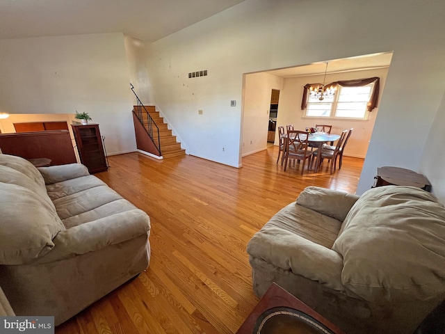 living room with a chandelier and light wood-type flooring