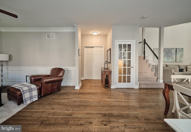 sitting room with dark hardwood / wood-style floors, ceiling fan, and ornamental molding