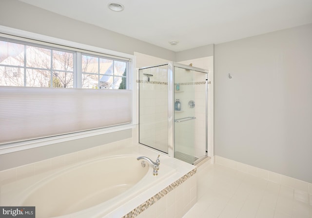 bathroom featuring shower with separate bathtub