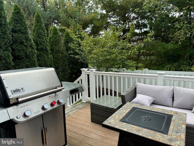 wooden deck featuring area for grilling and an outdoor hangout area