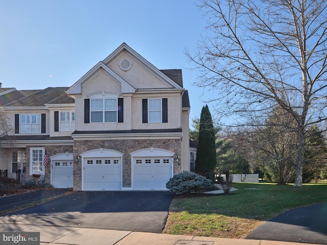 view of front of home featuring a front yard and a garage