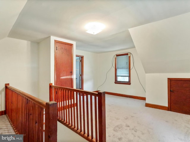 bonus room featuring light colored carpet and vaulted ceiling