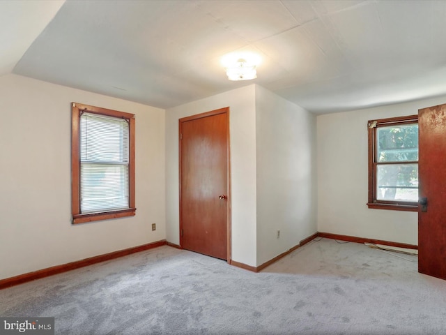 spare room featuring light colored carpet