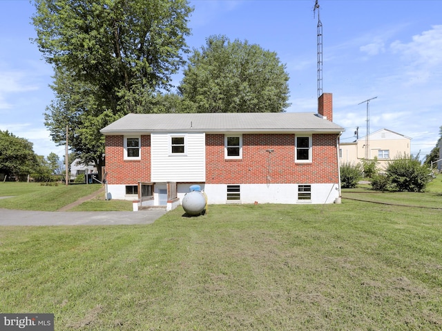 rear view of property featuring a yard