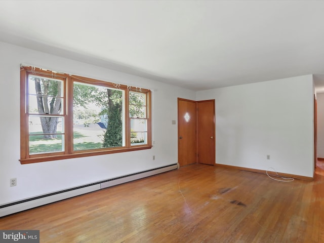 spare room with light hardwood / wood-style flooring and a baseboard radiator