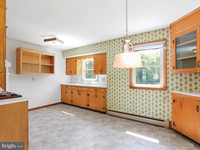 kitchen featuring a healthy amount of sunlight, hanging light fixtures, and a baseboard radiator