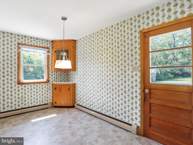 dining room featuring a wealth of natural light and baseboard heating